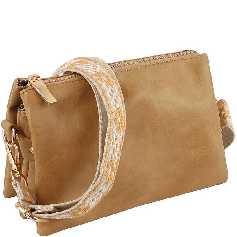 Tan leather crossbody bag clutch with a decorative woven guitar strap