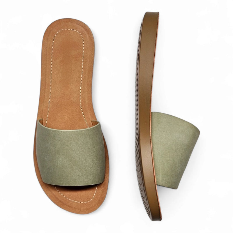 Pair of sage green leather slide sandals with tan soles from Daily Slip On Flat Sandal