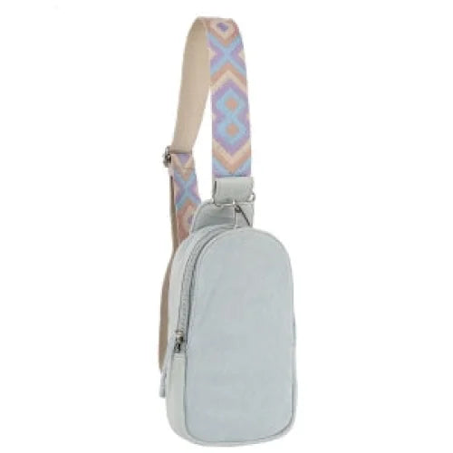 Light gray denim sling bag with a patterned Aztec guitar strap design