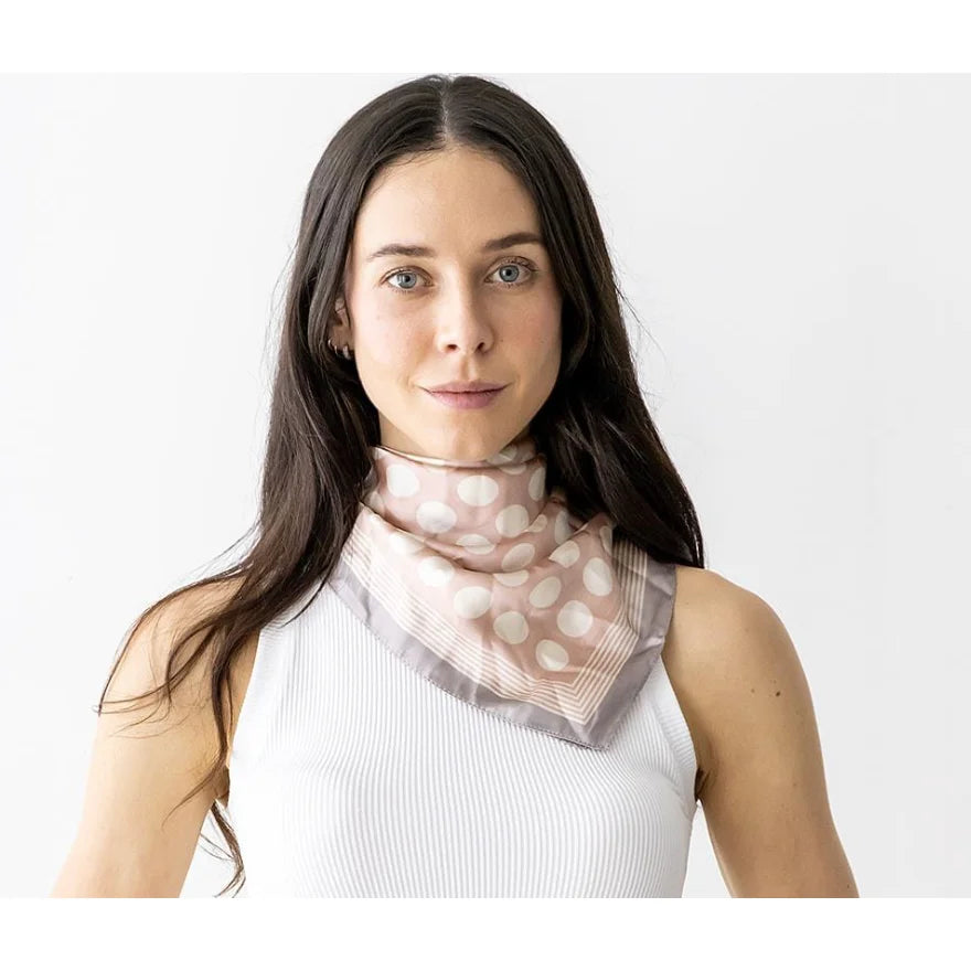 Woman with long dark hair in a white top showcasing a Dot Silky Neck Scarf