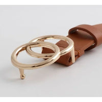 Gold-colored metal rings on a brown leather strap of the Double OO Skinny Belt