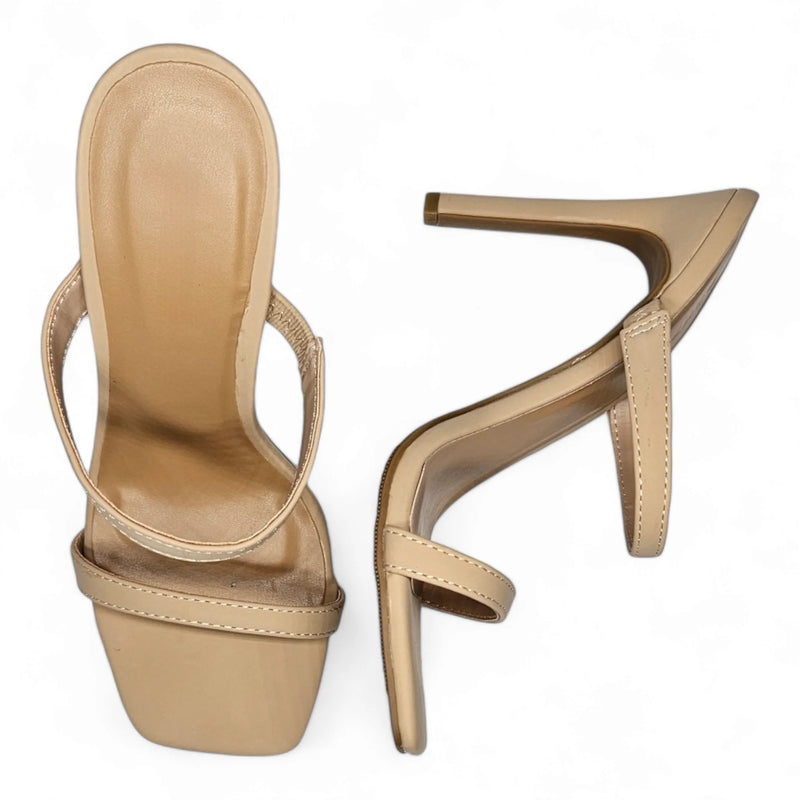 Beige high-heeled sandals with thin straps featuring a stylish double band design