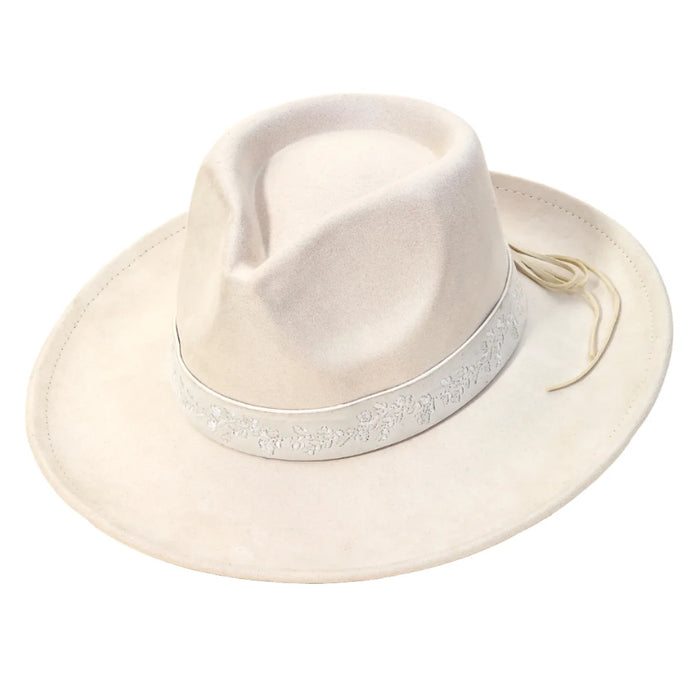 White wide-brimmed fedora hat with light-colored band and embroidered flower strap