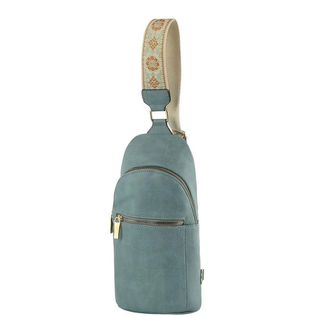 Teal leather sling backpack featuring a decorative fabric strap for the Fashion Zipper Strap