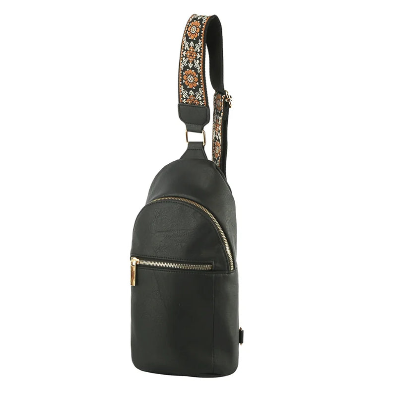 Black leather strap sling bag featuring a decorative embroidered fashion zipper strap