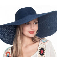 Woman wearing a floppy oversized sun hat in navy blue for stylish sun protection