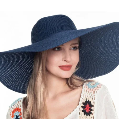 Woman wearing a floppy oversized sun hat in navy blue for stylish sun protection