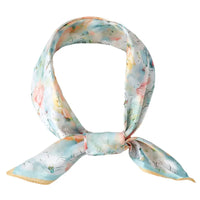 Silk scarf with pastel watercolor floral print, perfect for a stylish bandana neck