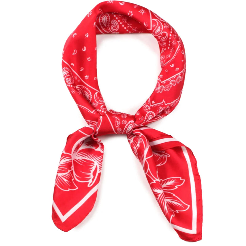 Red bandana satin scarf wrap with white paisley and floral patterns tied in a loop