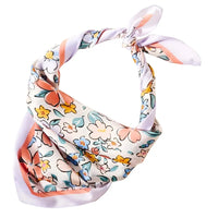 Floral Print Silk Scarf tied in a knot showcasing vibrant floral patterns