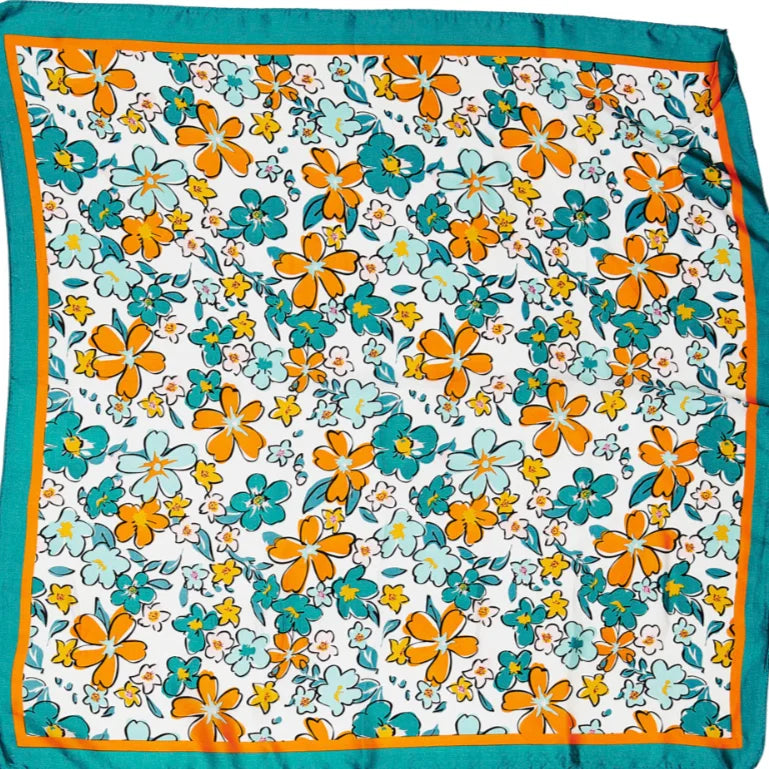 Floral print silk scarf featuring orange and teal flowers on a white background