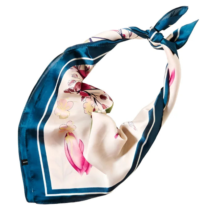 Silk scarf with floral pattern and blue border tied in a knot, flower pattern silky design