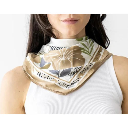 Silk flower print scarf featuring tropical floral and leaf designs in beige and blue