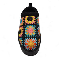 Colorful crocheted slipper with floral pattern and black trim, a stylish platform crochet clog