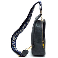 Black leather handbag with a patterned fabric strap for a stylish guitar strap sling