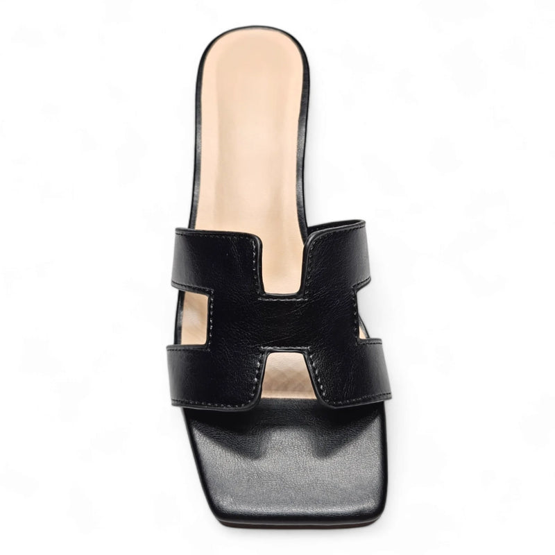 Black leather H Band Slide Sandal featuring a stylish cutout design on the upper