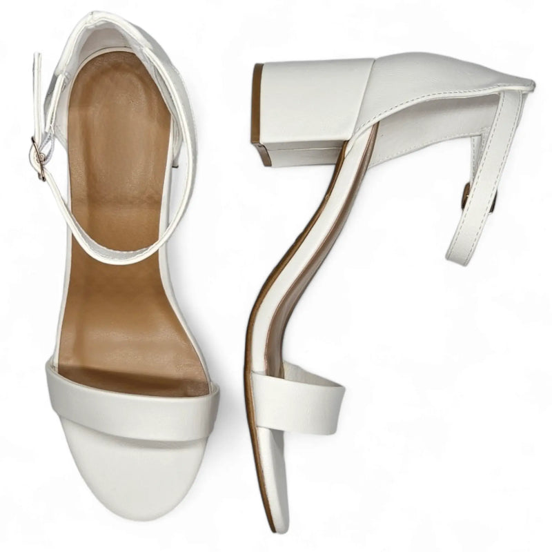 White high-heeled sandals with ankle straps and curved heels from Head Over Heels