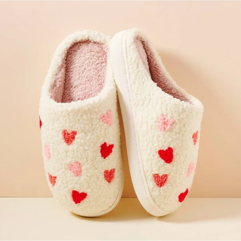 White cozy slippers with pink and red heart patterns for a warm, stylish feel