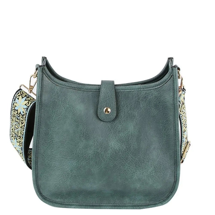 Teal leather hobo crossbody bag with decorative guitar strap for stylish outfits