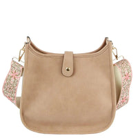 Beige leather hobo crossbody bag with decorative floral guitar strap