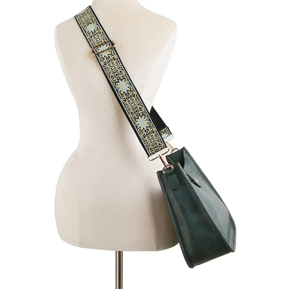 Mannequin torso showcasing a Hobo Crossbody Bag with decorative strap and black handbag