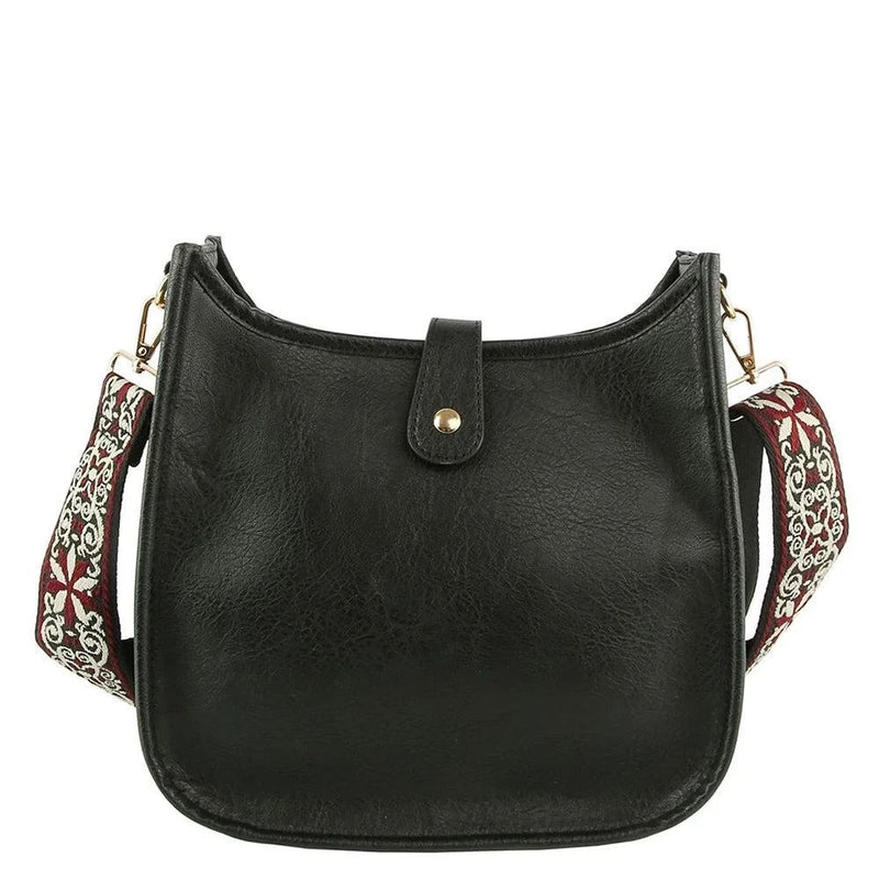 Black leather hobo crossbody bag with decorative strap and gold-tone hardware