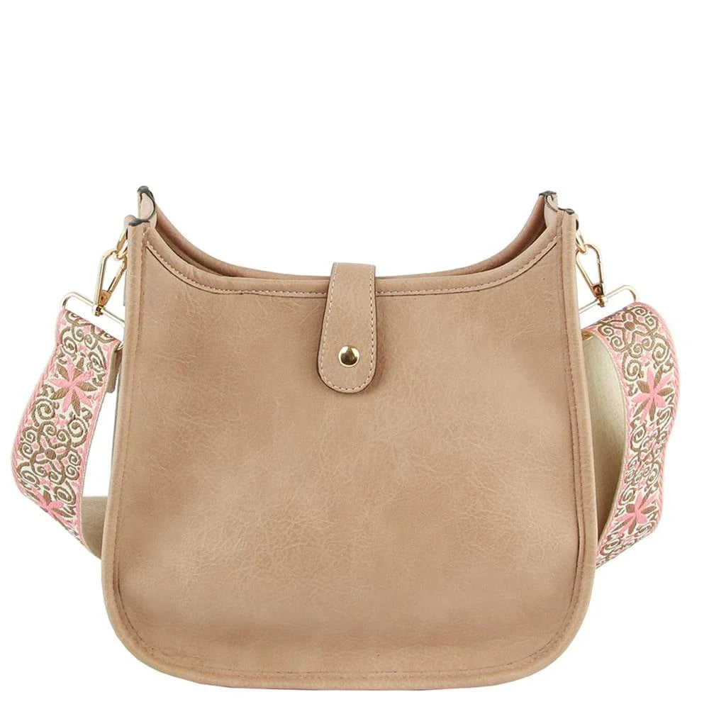 Beige leather hobo crossbody bag with decorative floral guitar strap