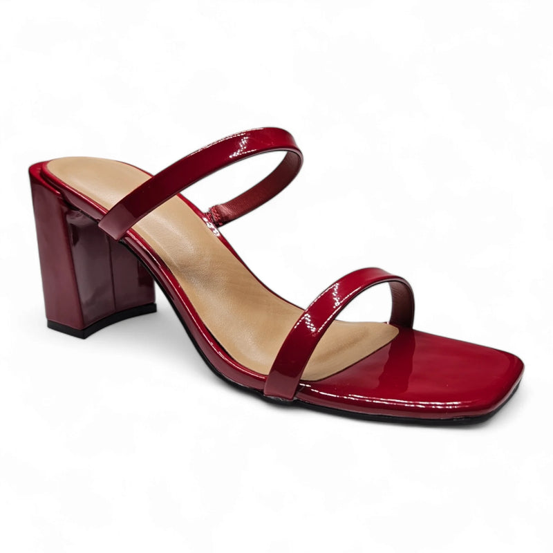 Red patent leather sandal featuring a classic double strap block heel design