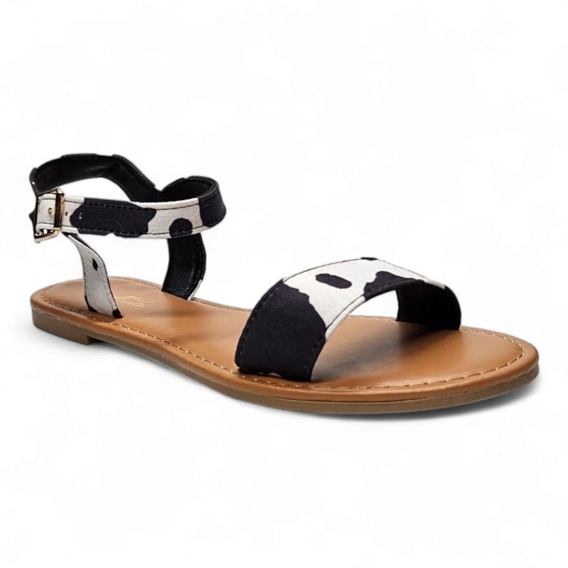 Flat Cow Print Sandal featuring black and white straps with a tan sole