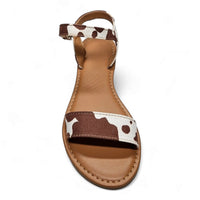 Sandal featuring a stylish cow print pattern on the strap for trendy flair