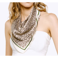 Leopard Print Silky Bandana with green border draped around the neck for stylish flair