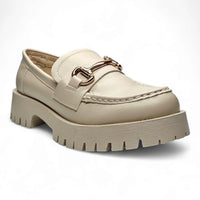 Chunky beige loafer with gold hardware and thick platform sole, featuring horse bit detail