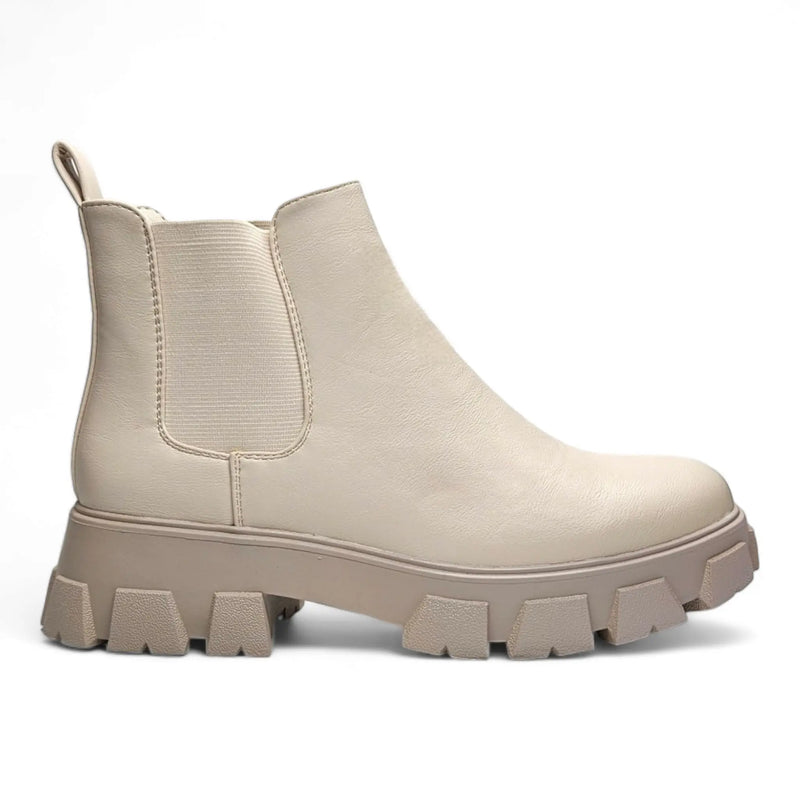 Beige chunky-soled Chelsea boot featuring a thick treaded sole for stylish lug platform combat boots