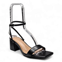 Black sandal with square open toe, ankle strap, and unique low block heel design