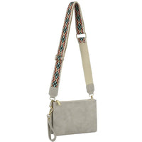 Beige multi compartment crossbody bag with colorful guitar strap for stylish versatility