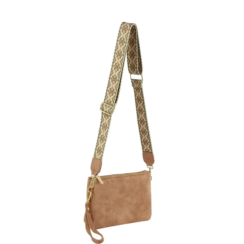 Tan leather multi compartment crossbody bag with a stylish patterned fabric strap