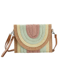 Woven straw crossbody bag with pastel rainbow arches and leather trim, multi colored striped design