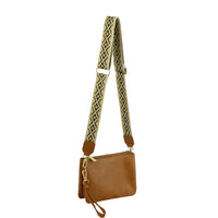 Brown leather multi compartment crossbody bag with patterned guitar strap