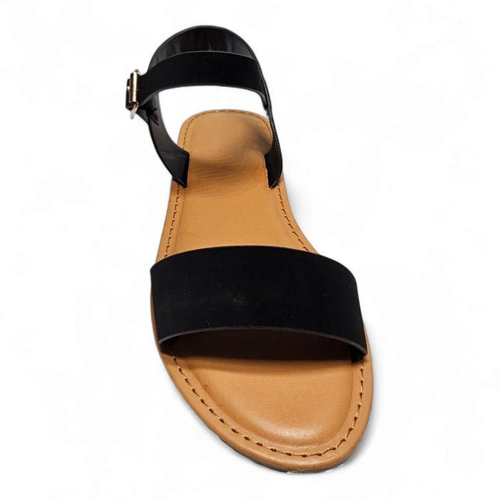 Black ankle-strap sandal with flat sole and tan footbed, perfect for summer style