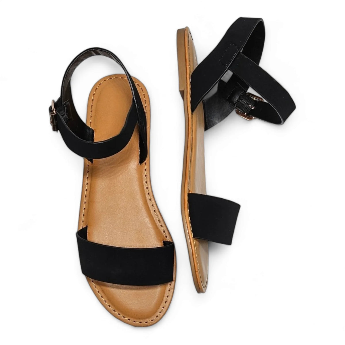 Black ankle-strap flat sandals with tan soles, perfect for Ocean Is Calling collection