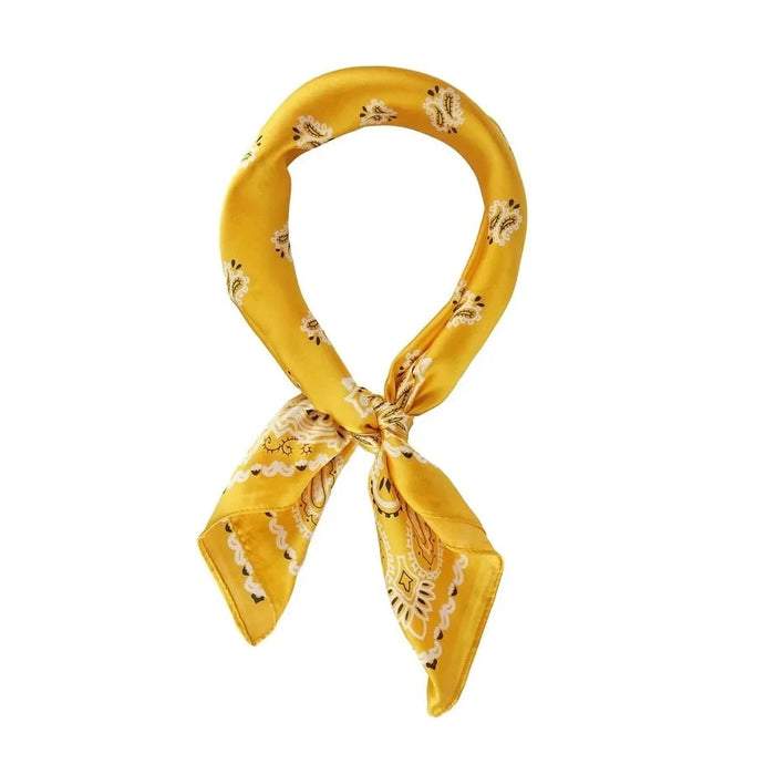 Yellow floral patterned Paisley Print Silk Scarf tied in a stylish loop