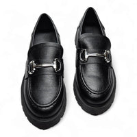 Pair of black leather loafers with silver hardware and stylish horsebit design