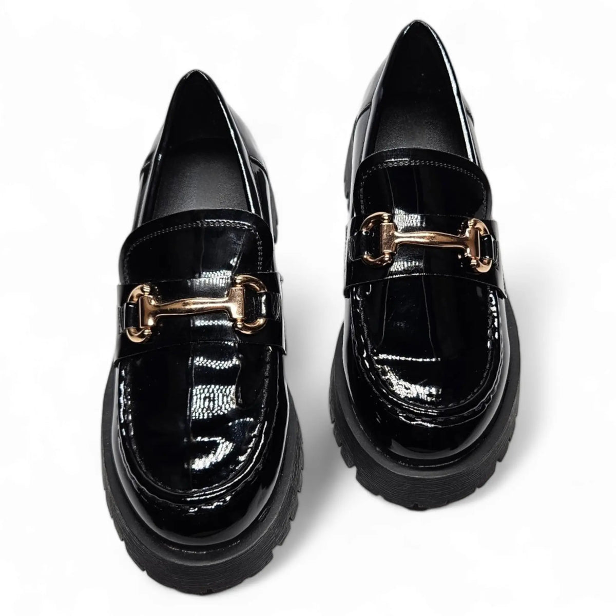 Glossy black loafers with gold hardware across the vamp for a stylish look