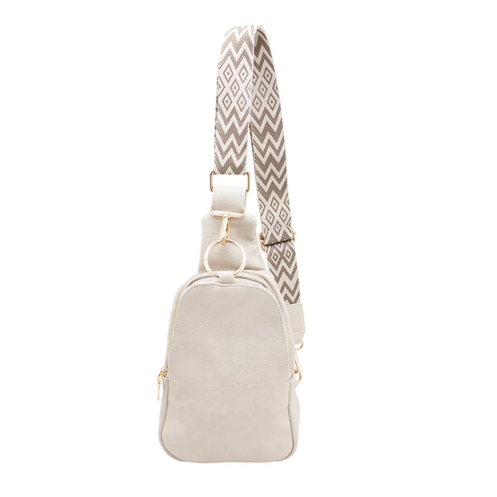 White leather Regina Sling Backpack with a stylish patterned strap