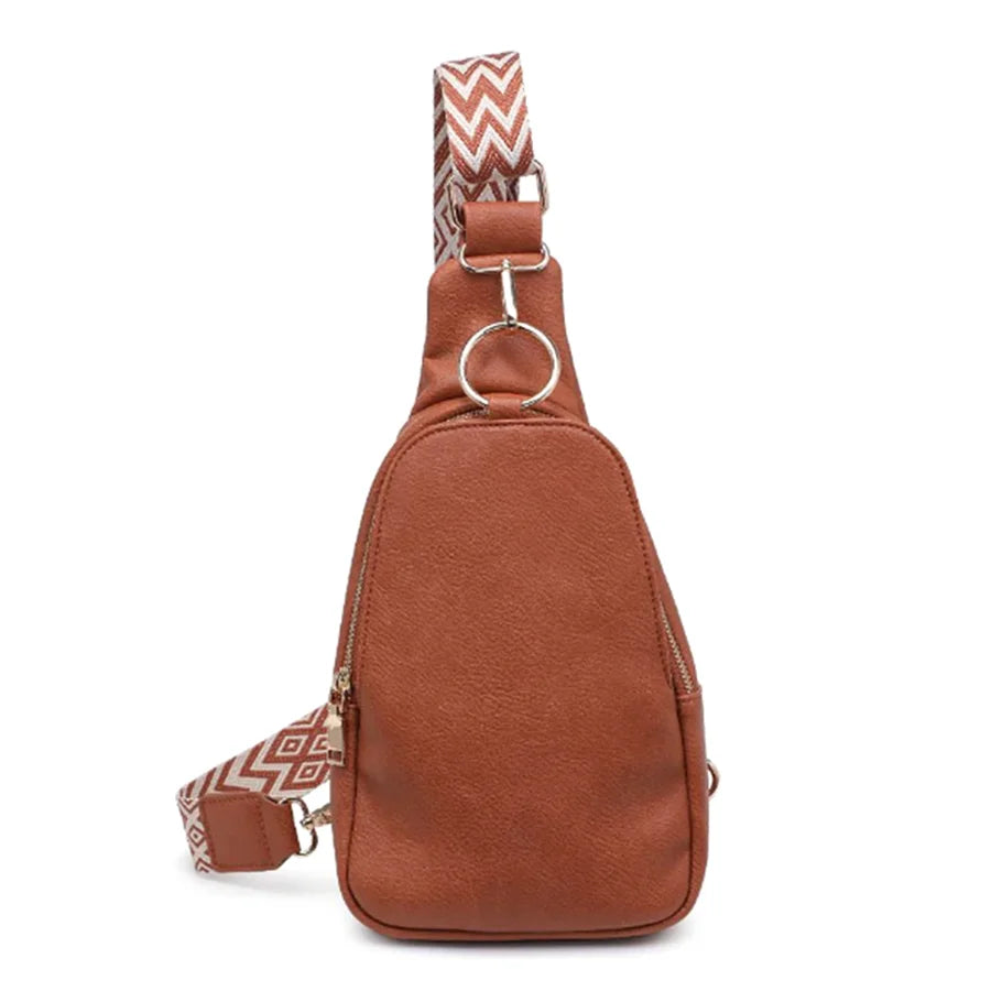 Brown leather Regina Sling Backpack with a stylish patterned strap