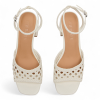 Pair of white sandals with open-toe design on a white background