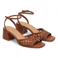 Brown woven sandals with block heels on a white background