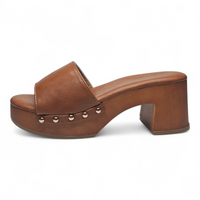 Brown leather clog shoe with studded details on a white background