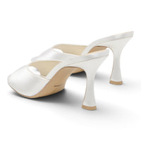 White satin heeled mule with open toe and open back, tall block heel.
