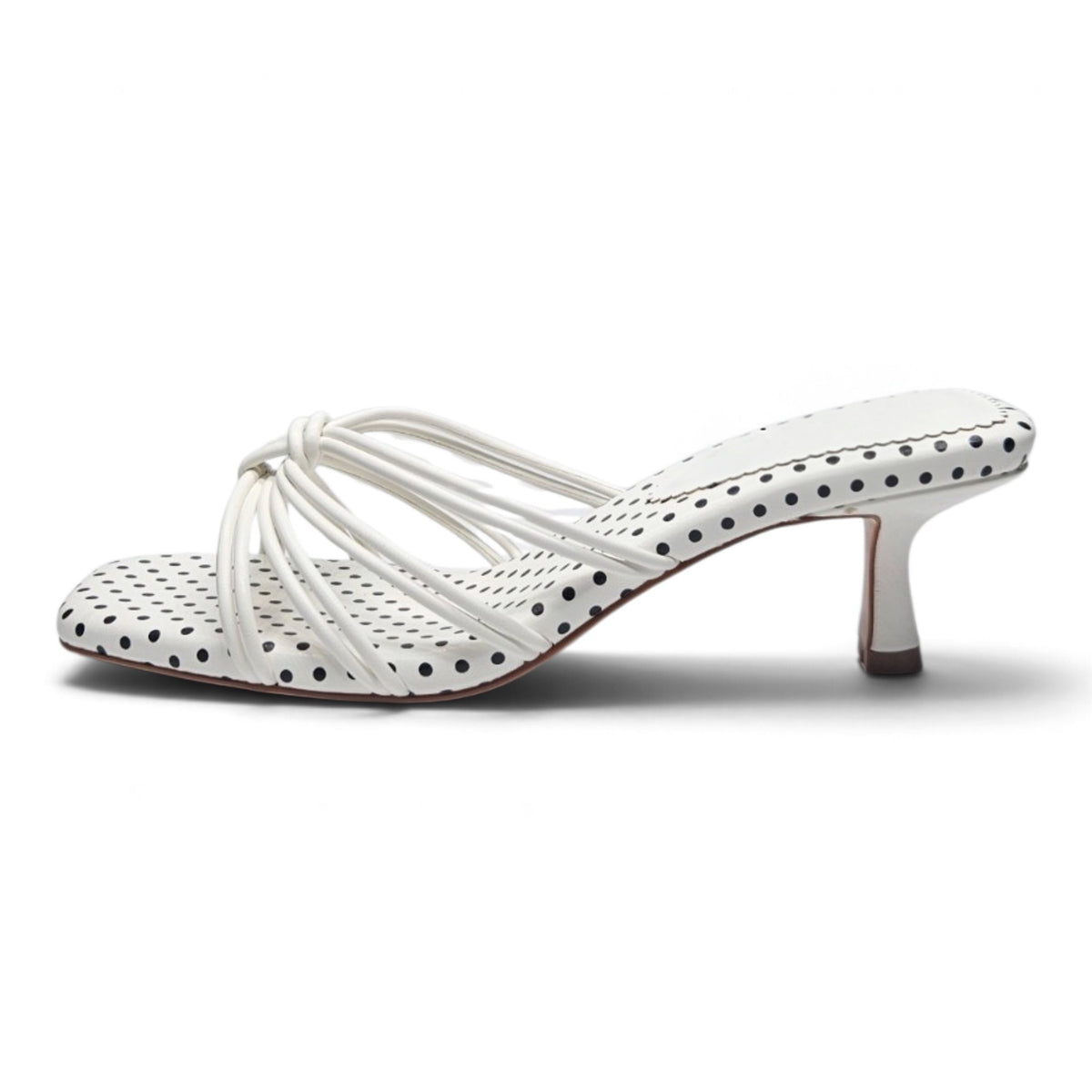 White polka dot strappy kitten heel sandal with crisscross knot straps and dark heel